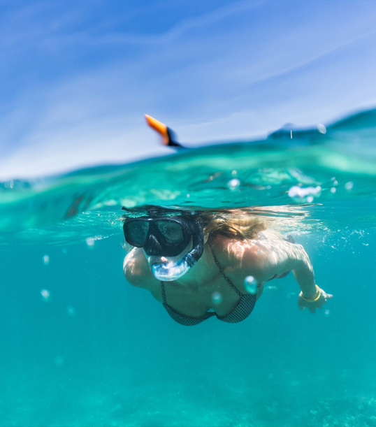 girl with mask and snorkel snorkeling in Terracina